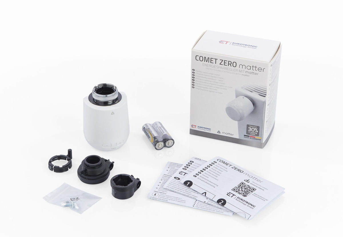Lieferumfang Comet Zero Matter: Regler, Verpackung, drei Danfoss-Adapter, zwei AA-Batterien und Kurzanleitung