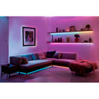 Ecksofa und Wandregale mit Hama LED-Streifen indirekt beleuchtet, Farbverlauf von Türkis nach Pink