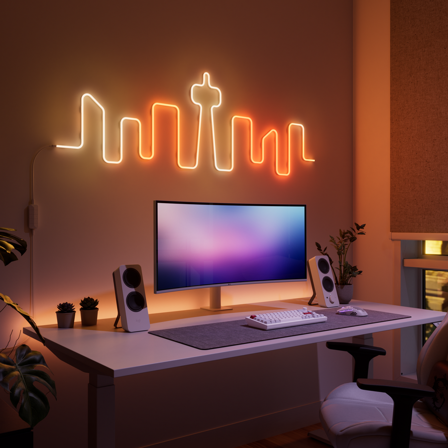 Nanoleaf Rope Light als Skyline über einem Schreibtisch geformt, warmes oranges Licht