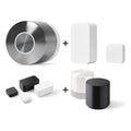 Schwarze Abdeckung für Nuki Door Sensor und Nuki Smart Lock Ultra u. a. nebeneinander vor weißem Hintergrund