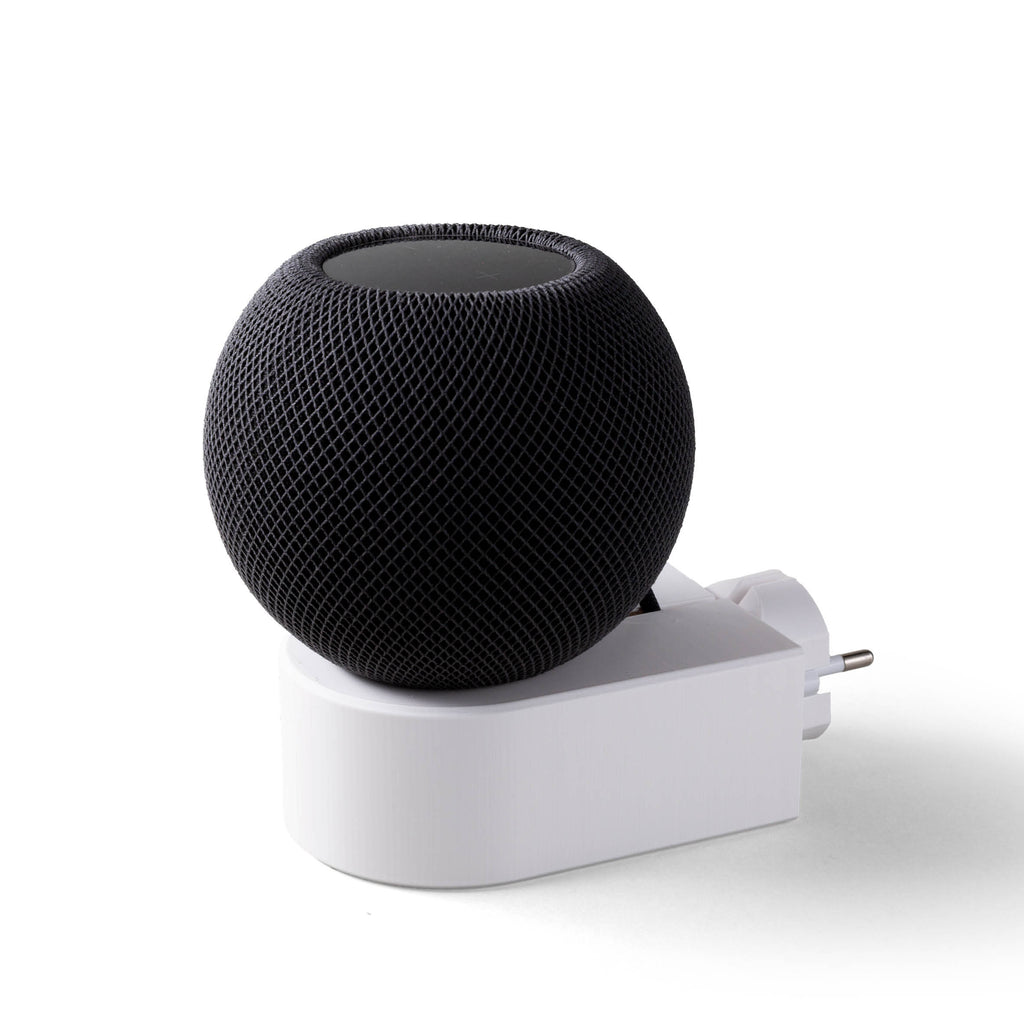 Schwarzer HomePod mini auf dem weißen smattex-Steckdosenhalter in einer Steckdose