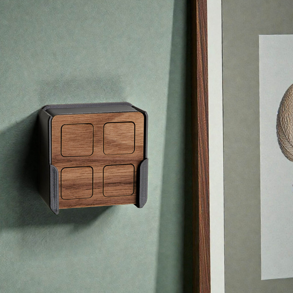 Fernbedienung aus Nussbaum in der Wandhalterung an grüner Wand neben einem gerahmten Bild